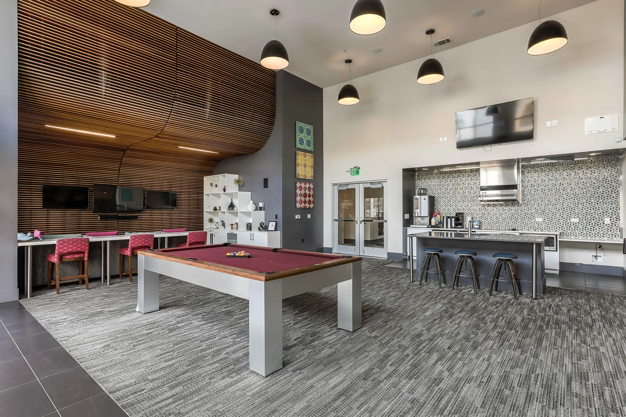 Clubhouse game room with pool table and kitchen