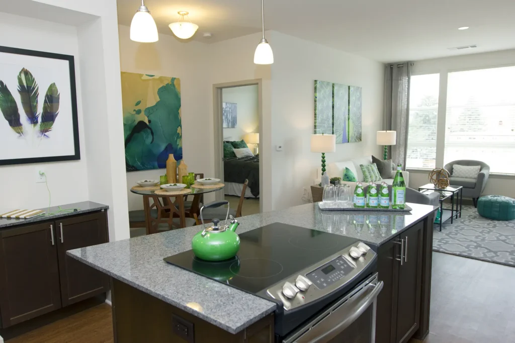 Kitchen with island, granite countertops, stainless steel appliances, and tile back splash
