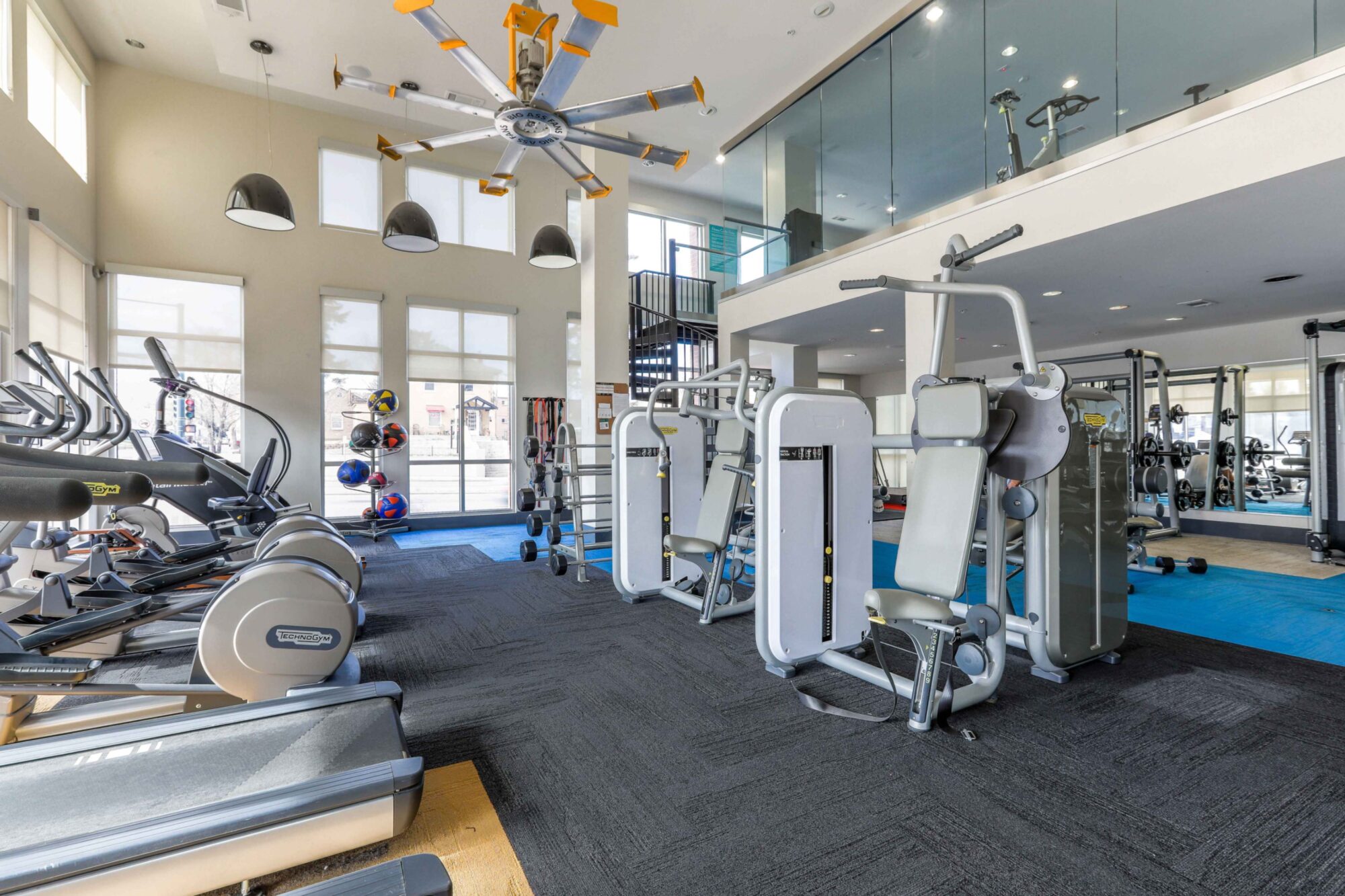 Fitness center with strength training equipment, cardio machines, and free weights